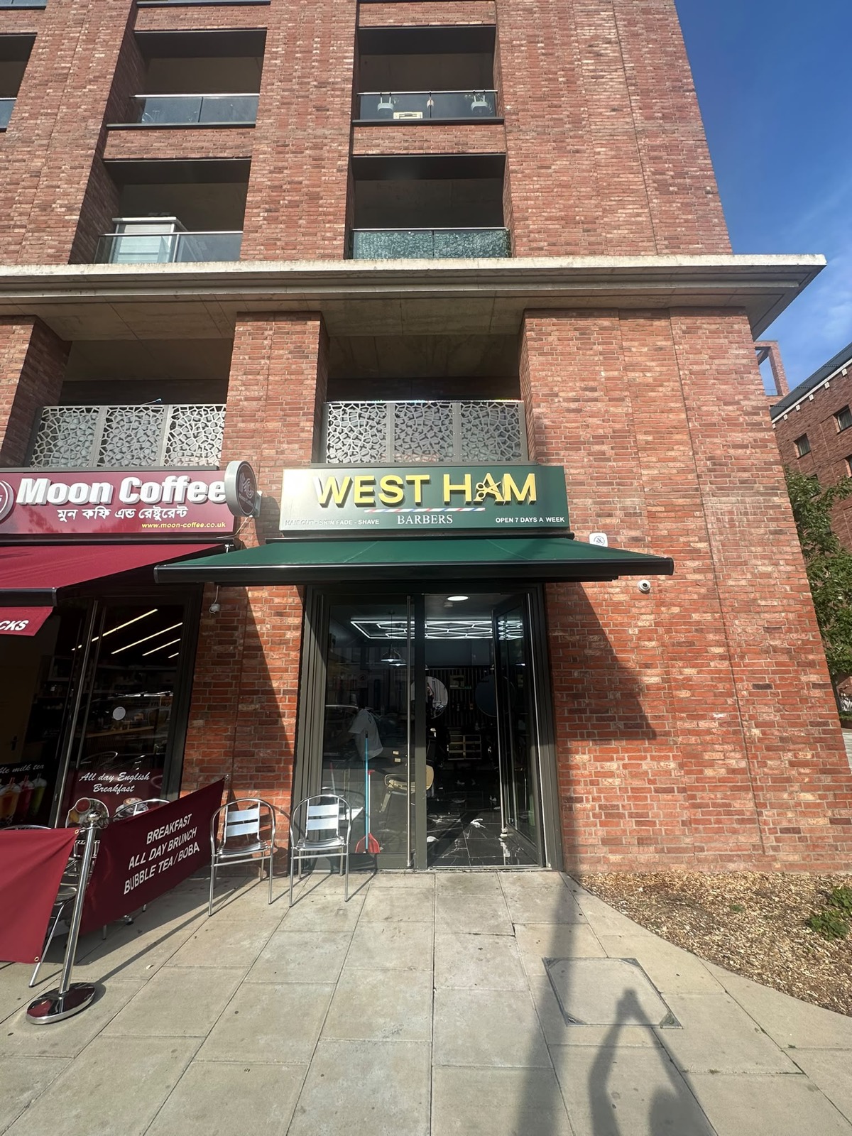 West Ham Barbers shopfront with green and gold signage